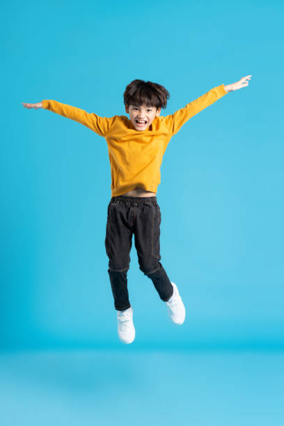 istock full body image of asian boy posing on blue background 1471103353