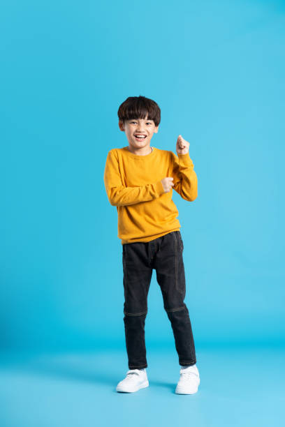 istock full body image of asian boy posing on blue background 1471103354