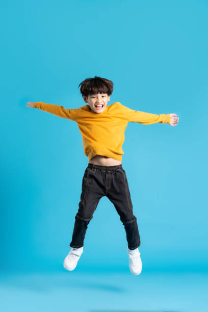 istock full body image of asian boy posing on blue background 1471103370