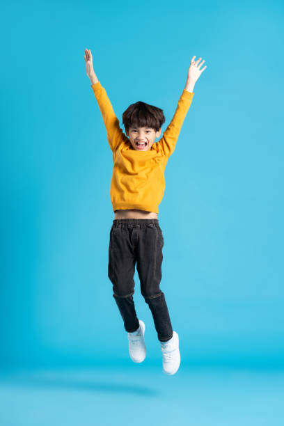 istock full body image of asian boy posing on blue background 1471103376