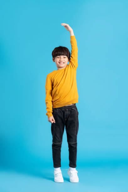 istock full body image of asian boy posing on blue background 1471103393