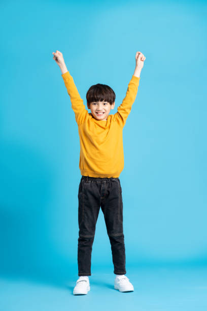 istock full body image of asian boy posing on blue background 1471103394