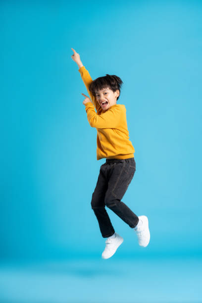 istock full body image of asian boy posing on blue background 1471103396