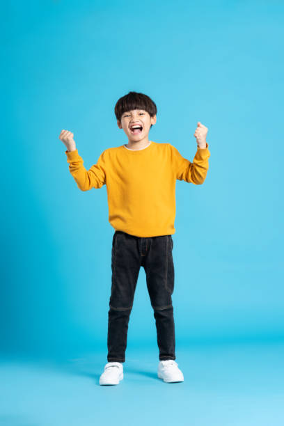 istock full body image of asian boy posing on blue background 1471103403