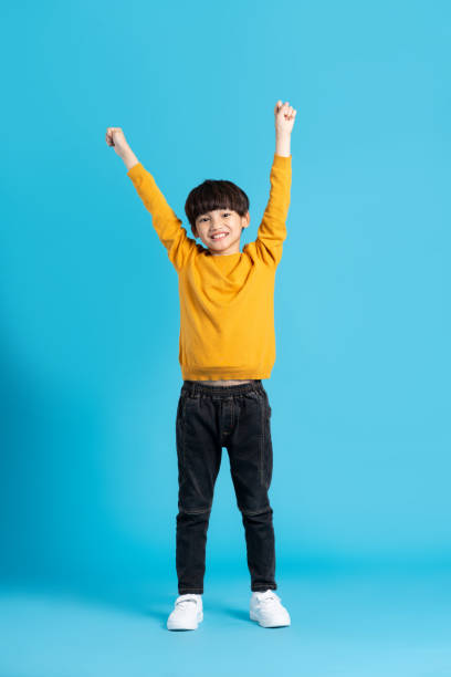 istock full body image of asian boy posing on blue background 1471103409