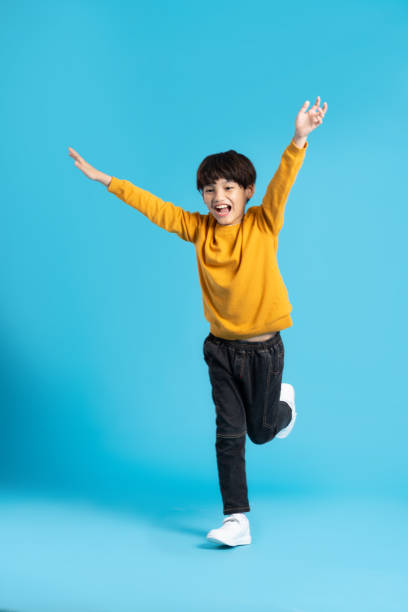 istock full body image of asian boy posing on blue background 1471103416