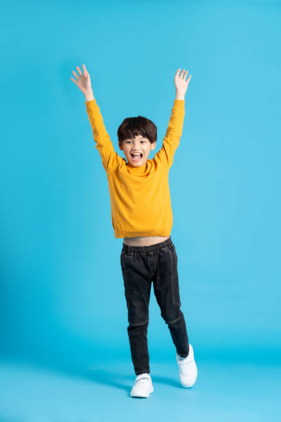 istock full body image of asian boy posing on blue background 1471103417