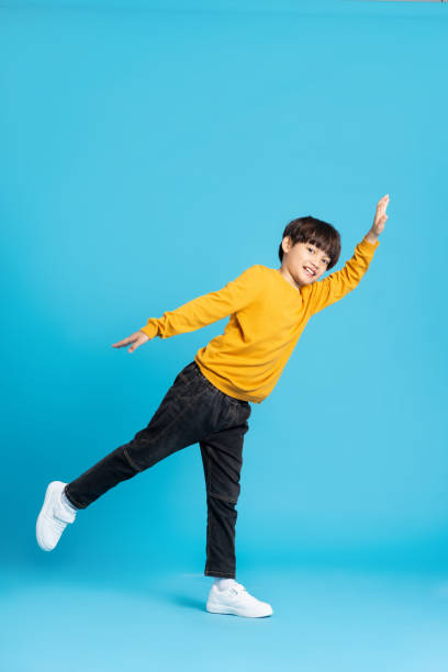 istock full body image of asian boy posing on blue background 1471103424