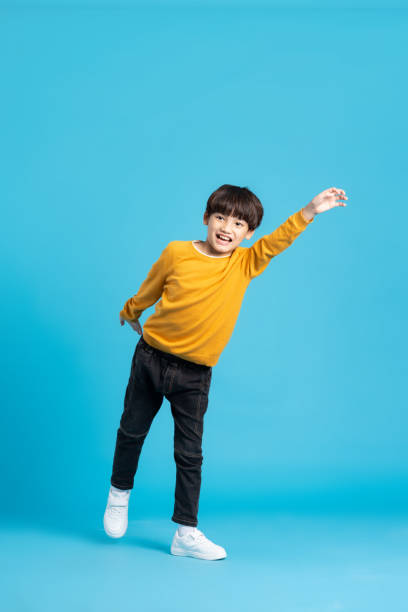 istock full body image of asian boy posing on blue background 1471103459