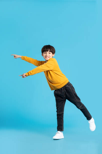 istock full body image of asian boy posing on blue background 1471103492