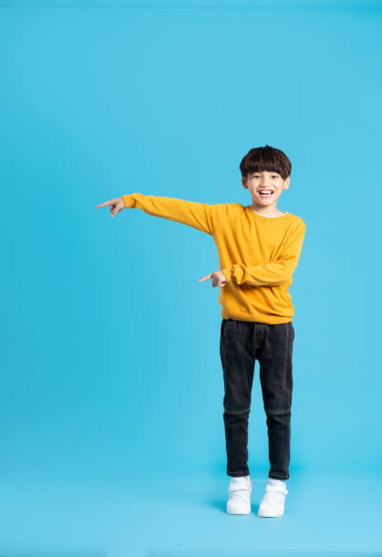 istock full body image of asian boy posing on blue background 1471103494
