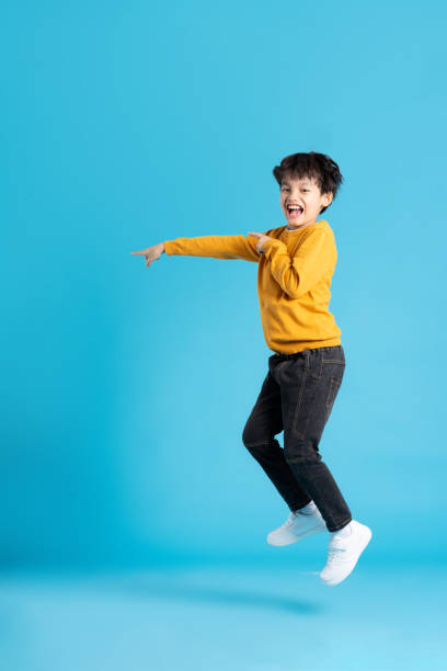 istock full body image of asian boy posing on blue background 1471103495
