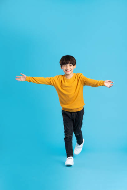 istock full body image of asian boy posing on blue background 1471103498