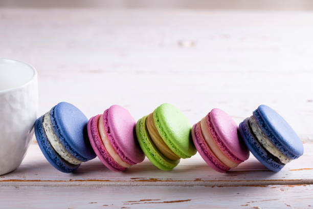 istock Border of multi-colored macaroons on a wooden background 1471111762