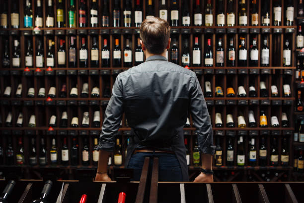 istock Bartender at wine cellar full of bottles with exquisite drinks 1471118455