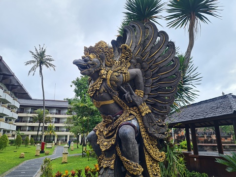 stone statue of the god Vishnu Kencana in a public park in Bali