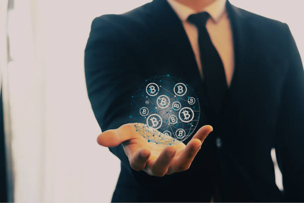 istock A businessman holding bitcoin symbols in his palms. 1471127880