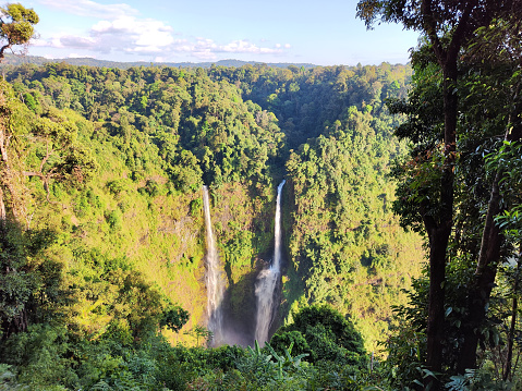 Majestic Tad Fane, in the Dong Hua Sao National Park on the Bolaven Plateau, Laos. It combines two rivers to form stunning twin 120m high waterfalls.