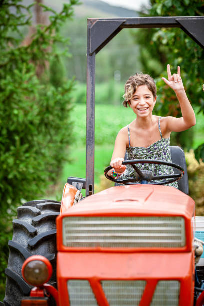 Young girl having fun on a tractor