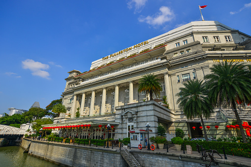 Singapore - Feb 9, 2018. Famous Fullerton Hotel with riverscene in Singapore. Singapore is global financial center with a tropical climate and multicultural population.