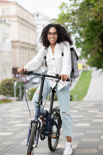 istock Happy woman riding a bicycle in a city 1471138043
