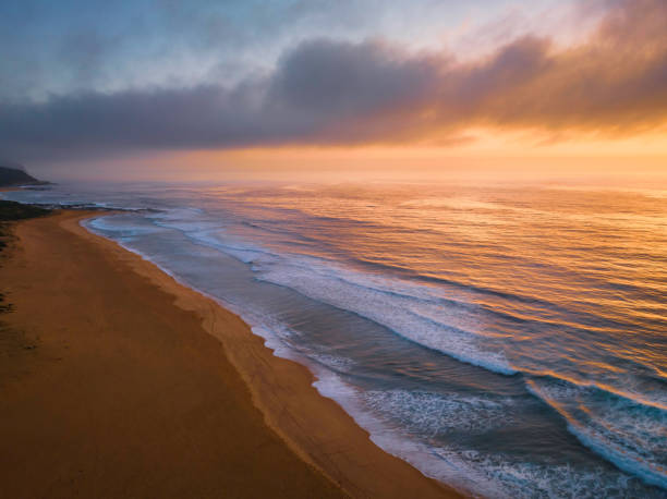 istock Summer sunrise at the seaside with clouds and haze 1471141035