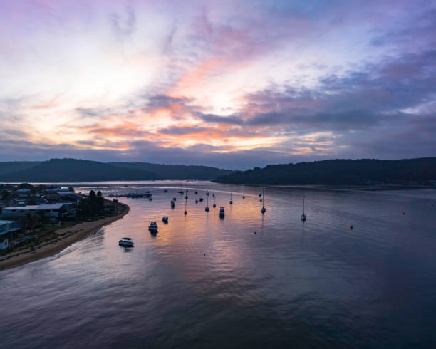 eine subtile sonnenaufgangslandschaft mit booten und wolken - australia new south wales aerial view landscape stock-fotos und bilder