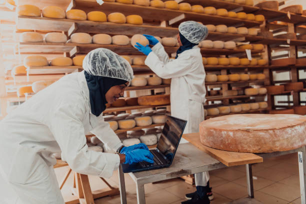 muslim business partners checking the quality of cheese in the modern industry - arabic characters imagens e fotografias de stock