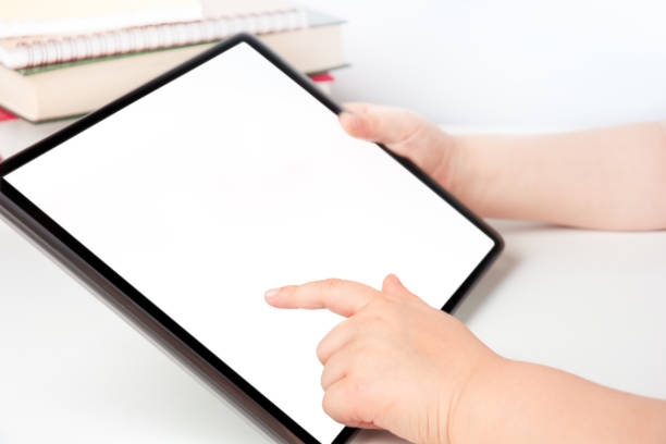 Child's hands holding digital tablet and touching blank screen, e-learning concept