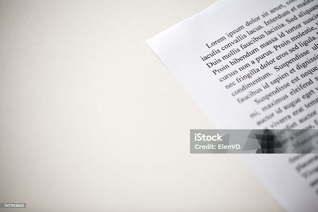 Lorem Ipsum text on printed on paper top paragraph, sample of document, space to copy text, side view, selective focus Angle Stock Photo