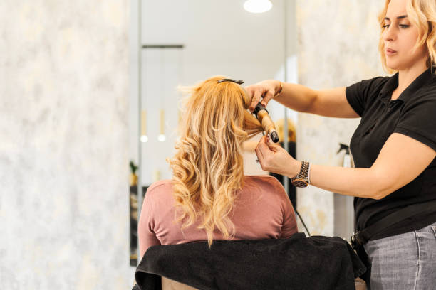istock Hairdresser using curling iron 1471144358