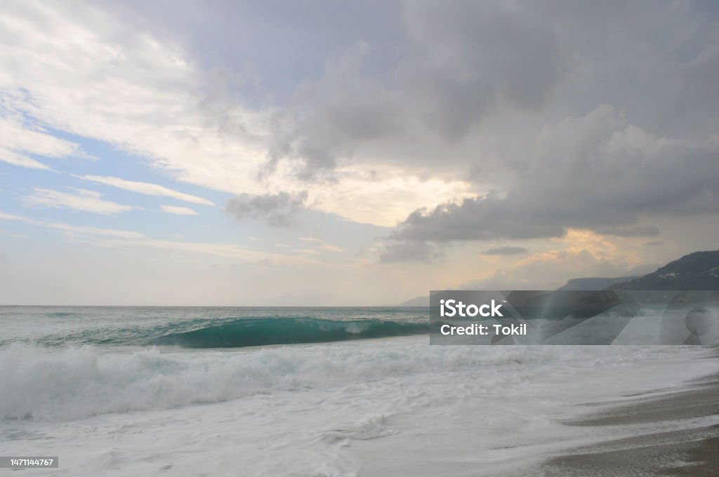 Big Wave on the Ligurian Sea at the Sunset During Summer Big Wave on the Ligurian Sea at the Sunset During Summer. Varigotti, Liguria, Italy Atmosphere Stock Photo