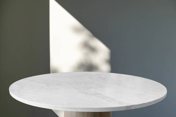 istock Marble table with window shadow drop on white wall background for mockup product display 1471148765