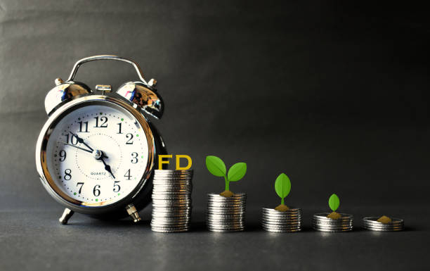istock Fixed deposit returns increasing concept with clock and money in focus. 1471148896