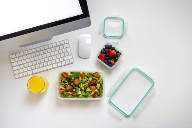 istock Reusable plastic boxes with salad and fresh berries at the work desk 1471151692