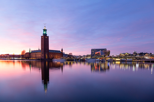 Aerial view of Stockholm city hall and illuminated cityscape at night in Stockholm, Sweden