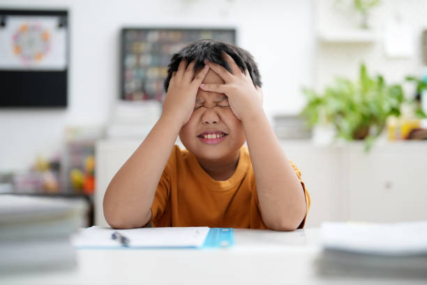 istock Worried young school boy studying at home 1471153972