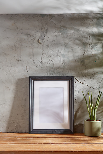 Empty Frame Over Gray Wall