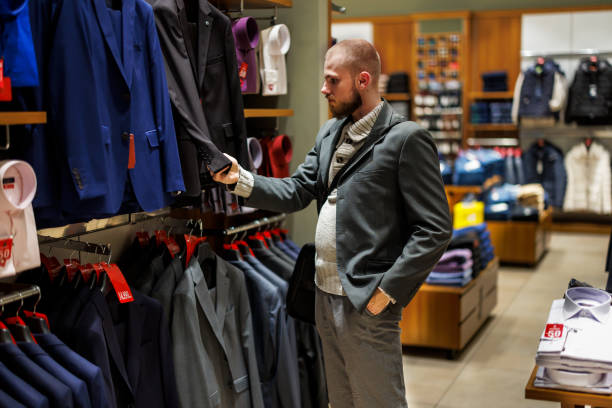 istock A stylish young man is feeling happy while shopping and choosing clothes. 1471154189