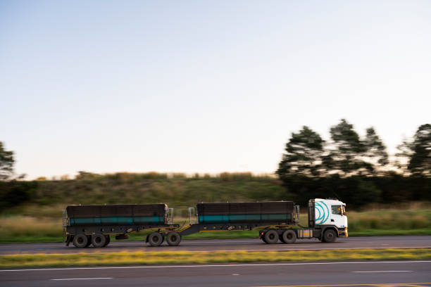 istock Side view double tipper trailer truck moving on highway 1471158085