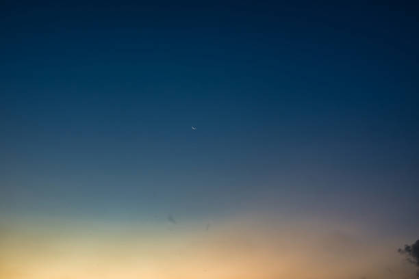 istock Golden hour sky with moon 1471158351