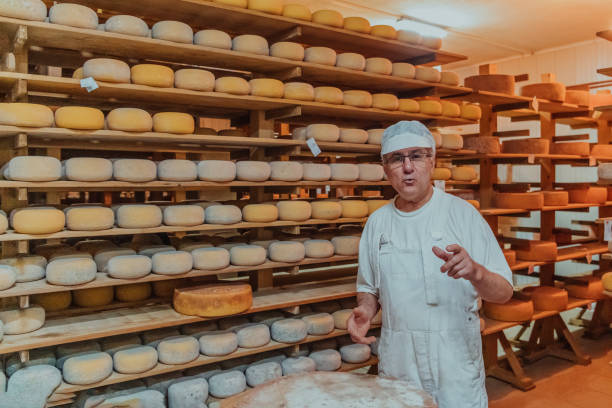 istock A worker at a cheese factory sorting freshly processed cheese on drying shelves 1471159426