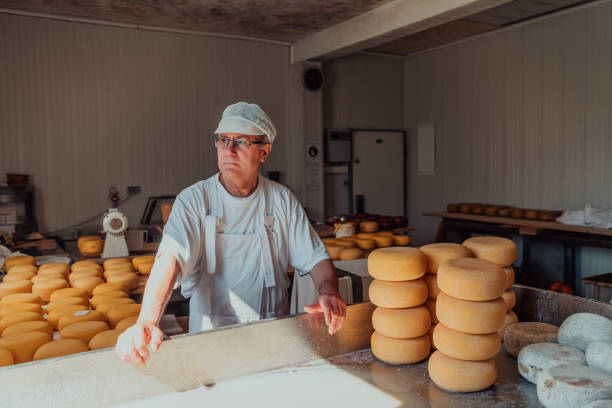 istock The cheese maker sorting freshly processed pieces of cheese and preparing them for the further processing process 1471163341