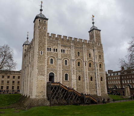 Tower Of London in London England United Kingdom During Daytime Blue Sky Clouds Solar Flare Beaming through Tree.