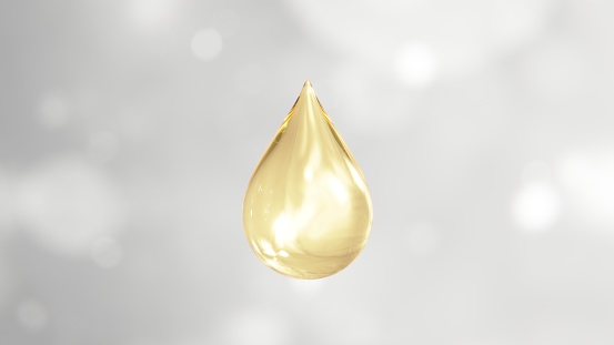 Gold luxury vitamin collagen droplet and light glow with white bokeh background.3D rendering for science and beauty cosmetic conceptual.