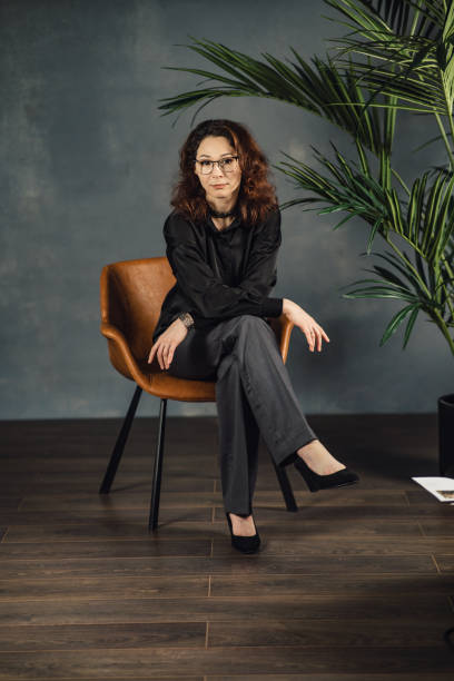 istock Middle-aged woman posing in the studio sitting on a chair 1471171390