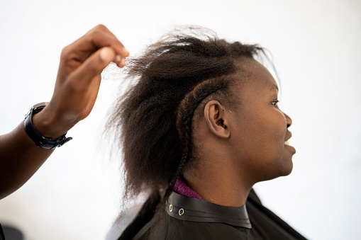 Young woman with natural black hair at LGBTQIA hairdresser
