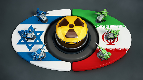 Rising tension between Israel and Iran. Missiles on Israeli and Iranian flags at the opposite sides of the yellow button with radiation symbol.