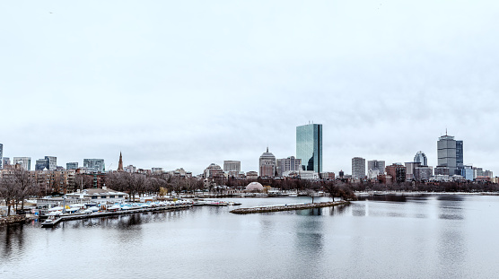 Boston skyline on a cold winter day as seen across the Charles River. The Charles River Esplanade along water's edge and Back Bay neighborhood are featured.