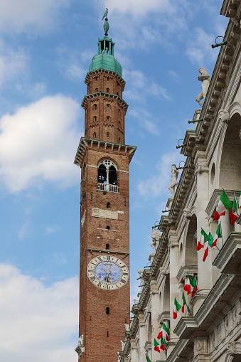 Tourists visiting the Piazza dei Signori, in the old town of Vicenza, where overlooks the majestic Basilica Palladiana. Rebuilt with the famous loggia in 1549 by Andrea Palladio, the building is listed in the UNESCO World Heritage Site together with other Palladian buildings in and around Vicenza.